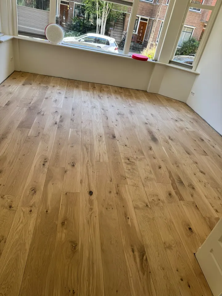 Dezelfde erkerkamer na schuren en afwerken, de eiken planken met noesten licht en met open nerf